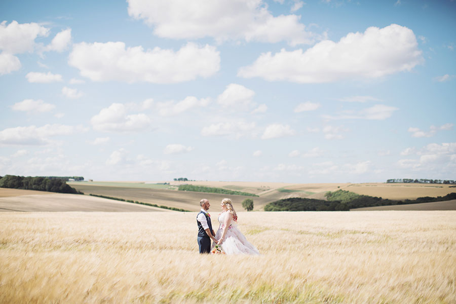 Driffield natural wedding photography at unique field festival venue Wold Top Brewery with a photo of the bride and groom shoot in a corn field by Sasha Lee Photography