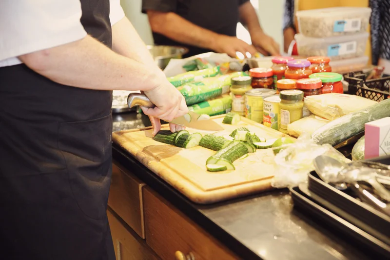 Chopping homely wedding food at Blencowe Hall, The Rowley Estates, Lake District wedding