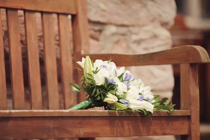 Wedding bouquet on a bench at Blencowe Hall, The Rowley Estates, Lake District wedding