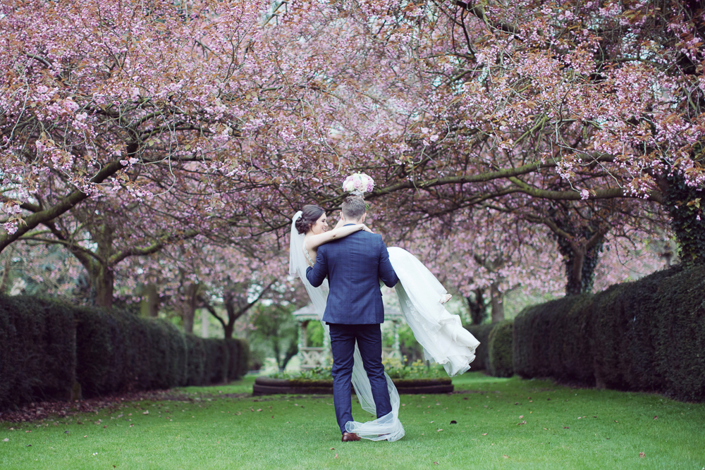 UK wedding venue with cherry blossom Hazlewood Castle with natural wedding photography by Sasha Lee Photography