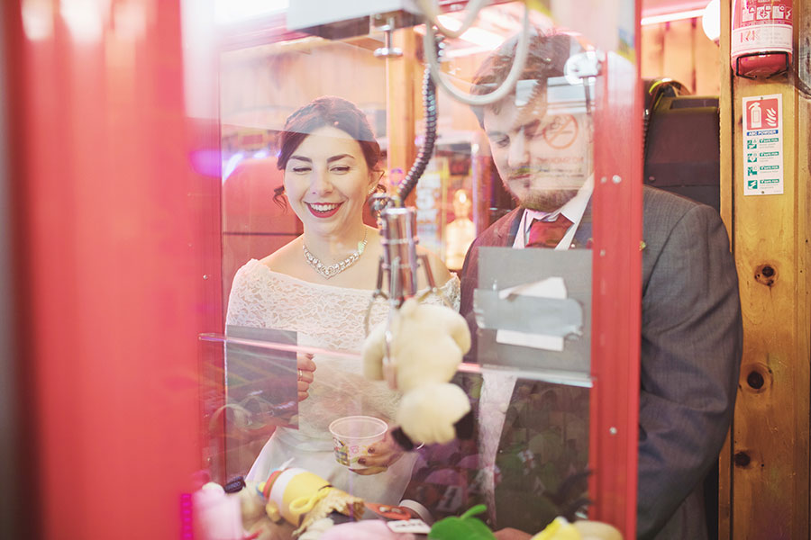 Matlock Bath wedding | Amusement park penny slot machine bride and groom shoot | Matlock Bath wedding photographer | Natural wedding photography