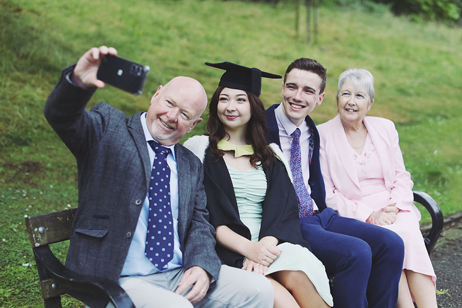 Group of Sheffield Hallam University graduates celebrating on graduation day