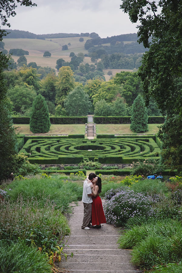Surprise marriage proposal at Chatsworth House with scenic gardens in the background.