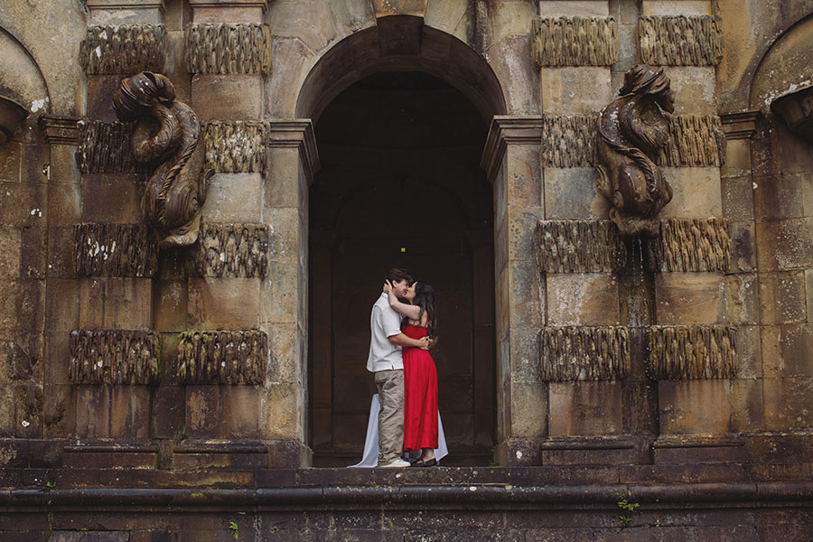 Couple sharing a romantic proposal moment in the gardens of Chatsworth House, Derbyshire