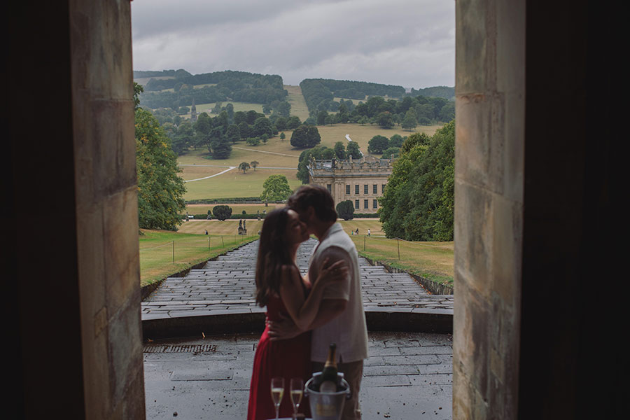 Engagement proposal captured in front of the historic Chatsworth House mansion.