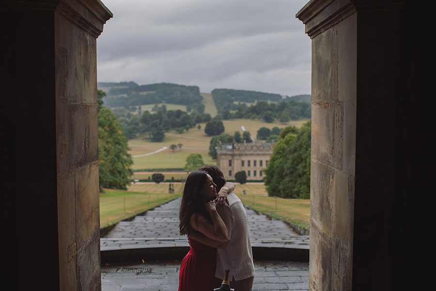 Engagement proposal captured in front of the historic Chatsworth House mansion.