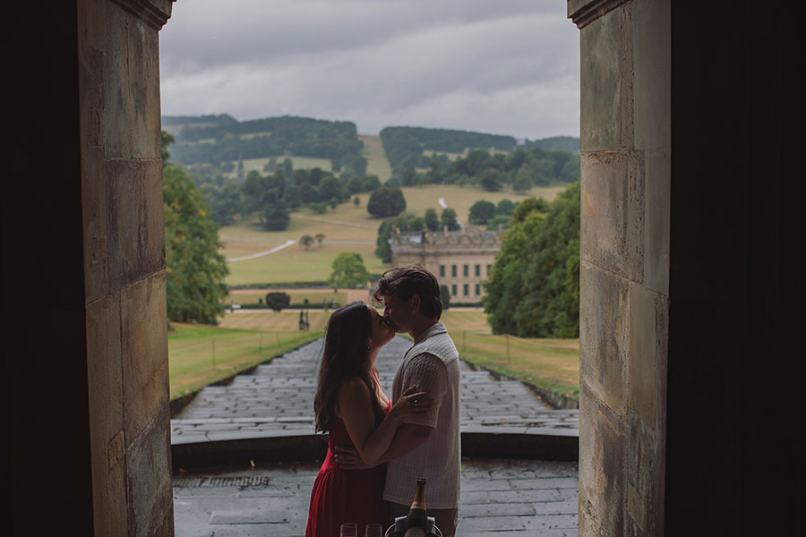 Engagement proposal captured in front of the historic Chatsworth House mansion.
