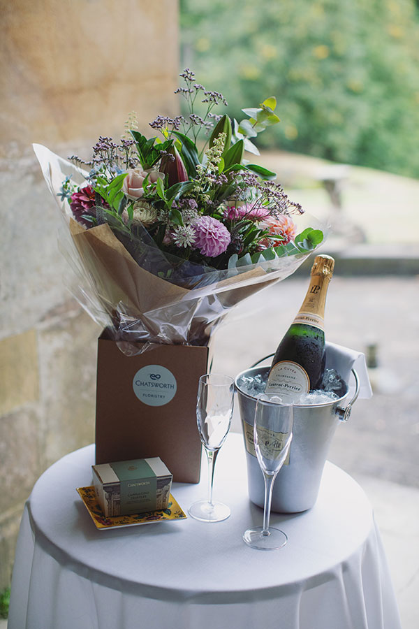 Couple sharing a romantic proposal moment in the gardens of Chatsworth House, Derbyshire