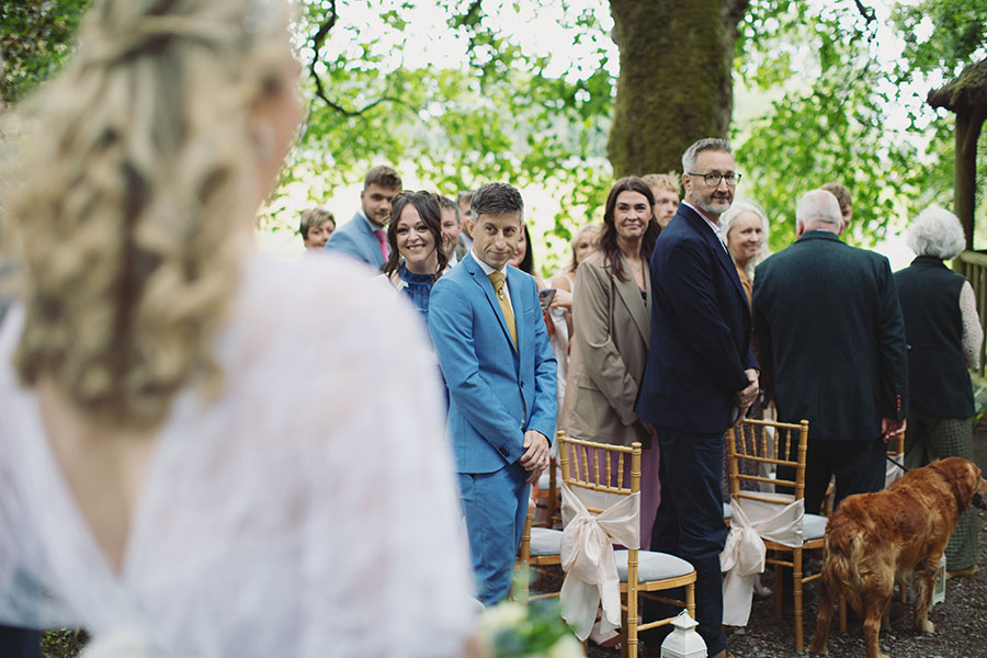 Relaxed candid photo of the small wedding party enjoying the sunshine at Biggin Hall Hotel in the Peak District.