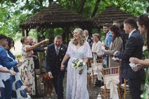Bride and groom walking hand-in-hand through the gardens during their Biggin Hall Hotel wedding in the Peak District.
