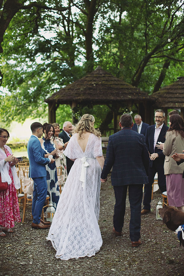 Relaxed candid photo of the small wedding party enjoying the sunshine at Biggin Hall Hotel in the Peak District.