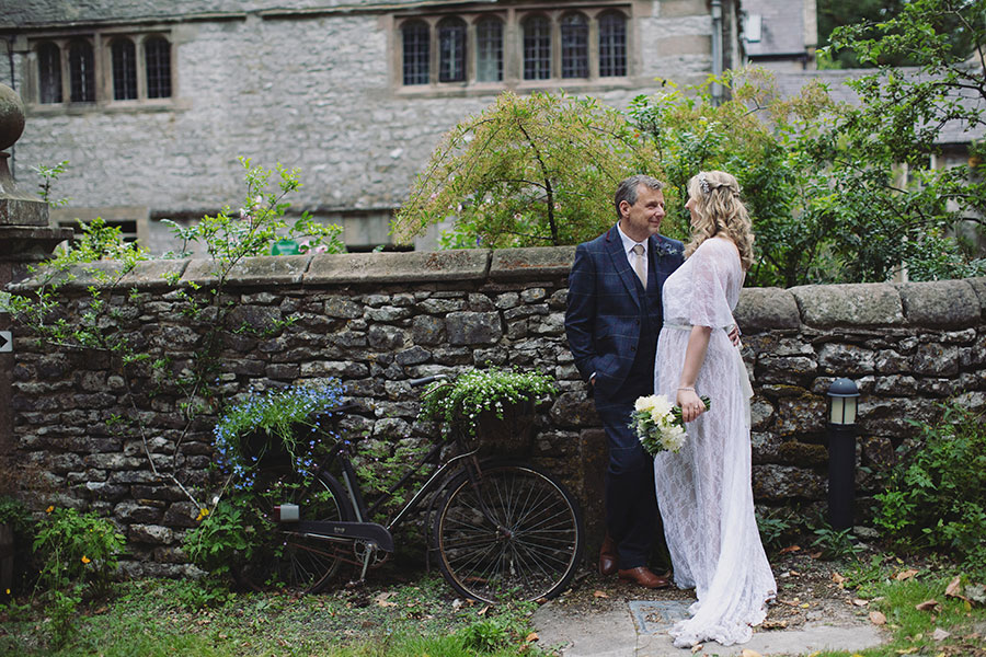 Wedding portrait of the bride and groom in front of the historic Biggin Hall Hotel building.