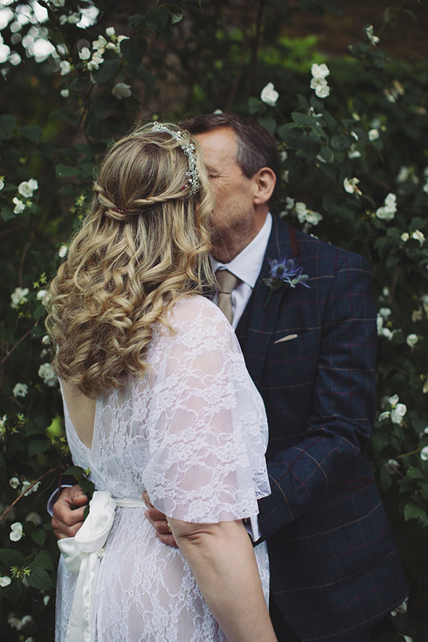 Wedding portrait of the bride and groom in front of the historic Biggin Hall Hotel building.