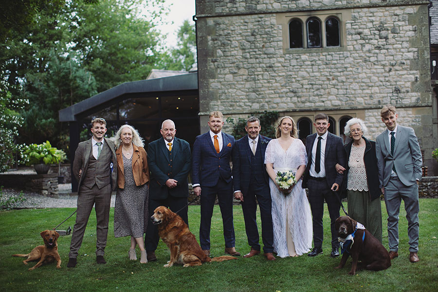 Wedding portrait of the bride and groom in front of the historic Biggin Hall Hotel building.