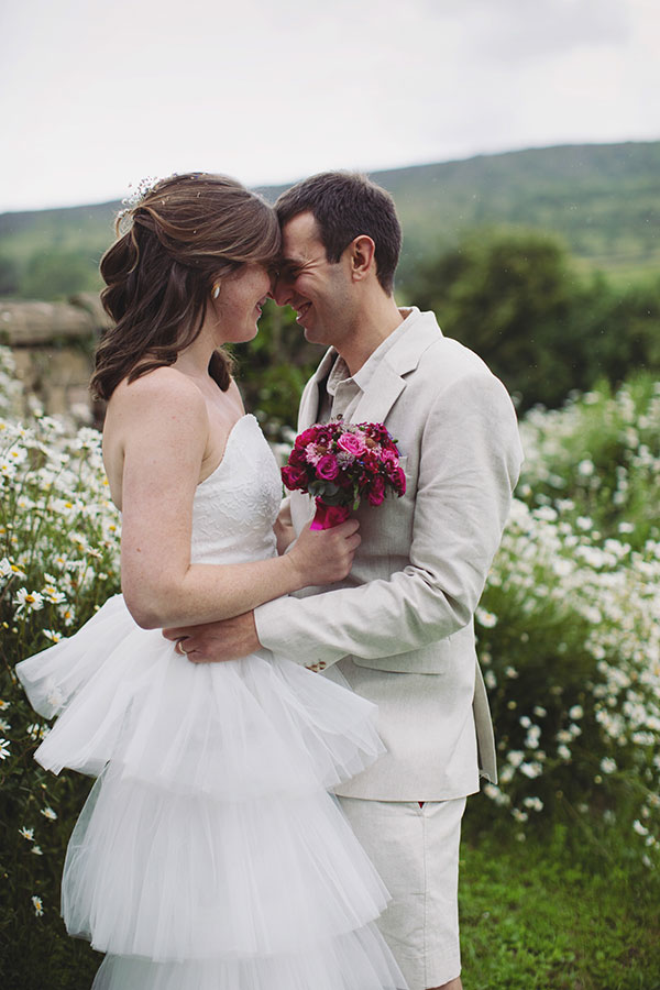 Bride and groom walking through the grounds during their Cliff College wedding photography session in Hope Valley.