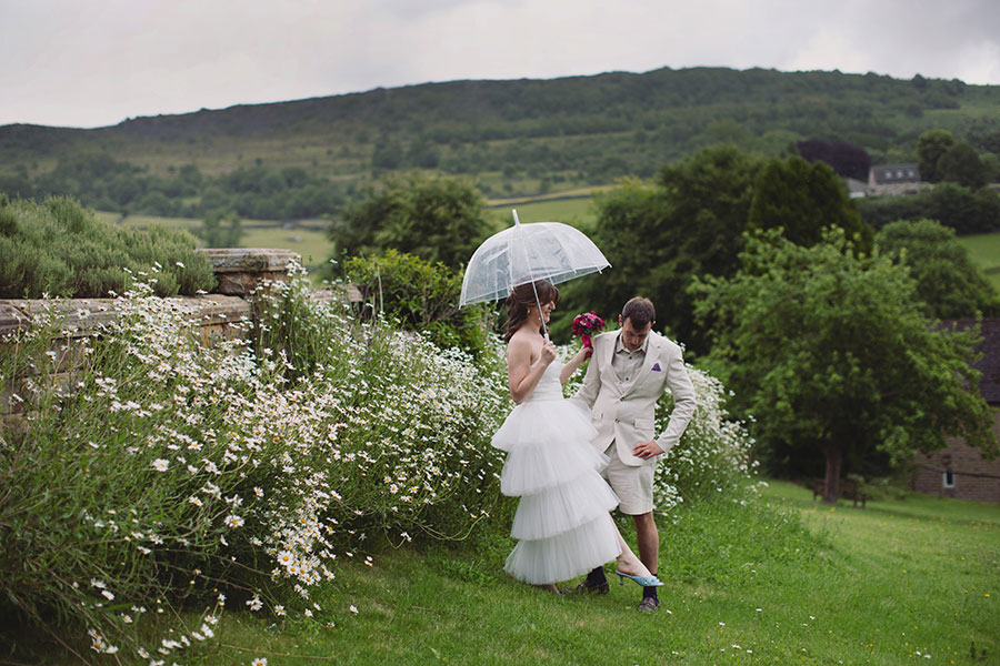 Bride and groom walking through the grounds during their Cliff College wedding photography session in Hope Valley.