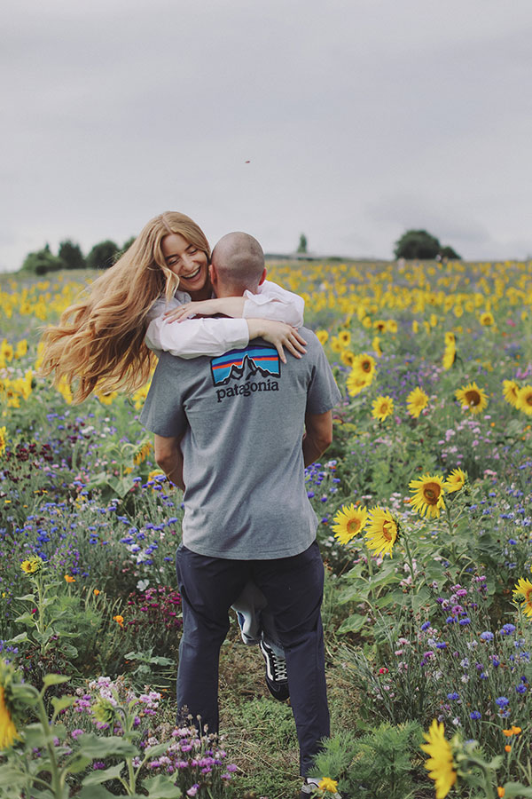Natural engagement photos of couple in sunflower field at Barlow Sunflower Field