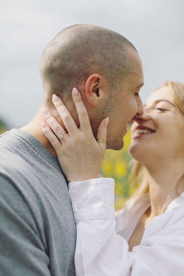 Natural engagement photos of couple in sunflower field at Barlow Sunflower Field
