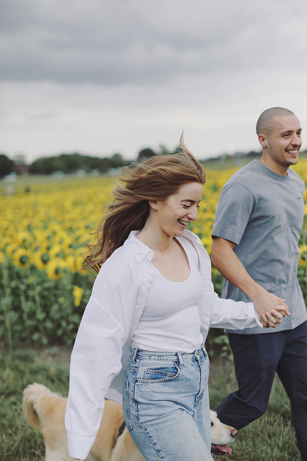 Ellie and Kamen smiling together during their Barlow Sunflower Field engagement photoshoot