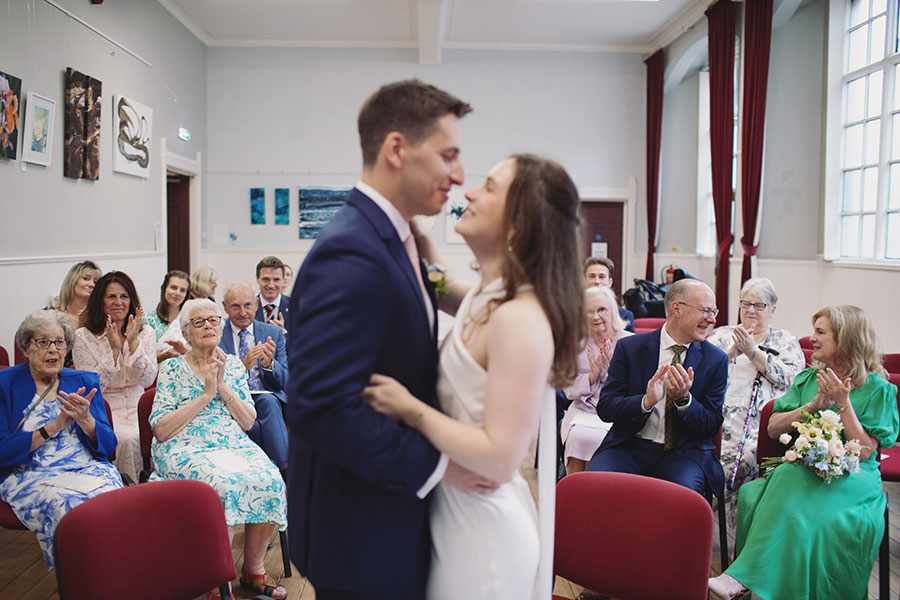 Couple exchanging vows inside Bakewell Town Hall — candid Derbyshire wedding photography