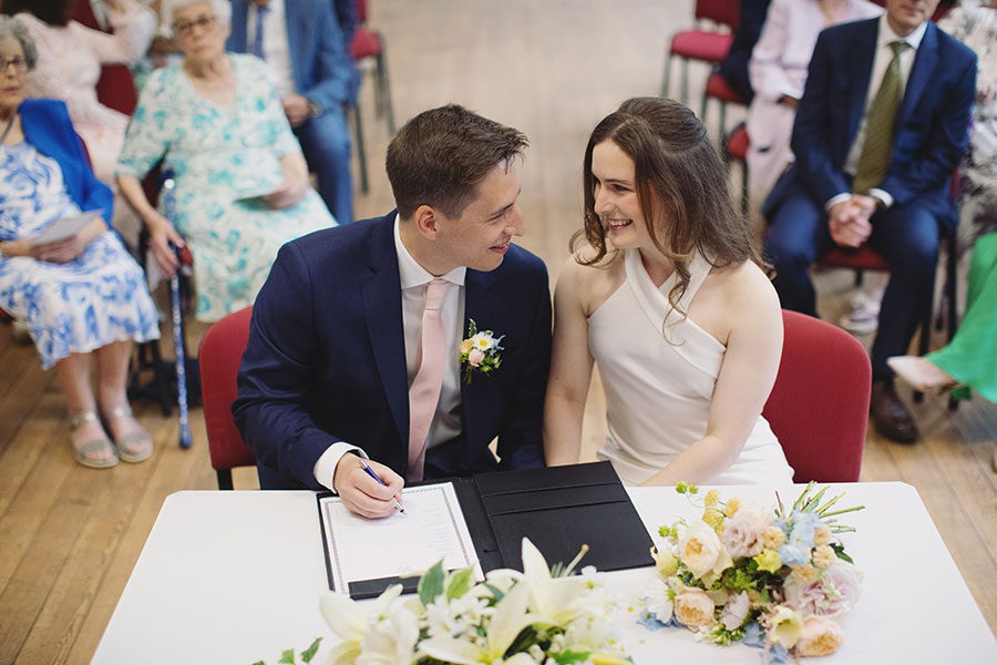 Couple exchanging vows inside Bakewell Town Hall — candid Derbyshire wedding photography