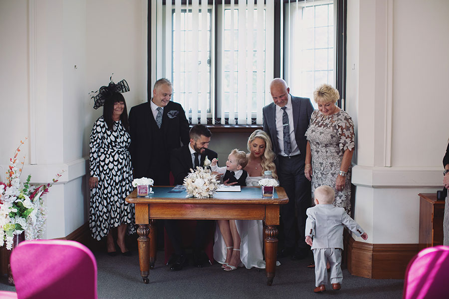 Couple signing the register during their Sheffield Town Hall wedding ceremony
