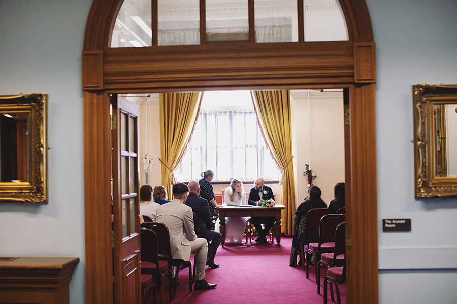 Couple signing the register during their Sheffield Town Hall wedding ceremony