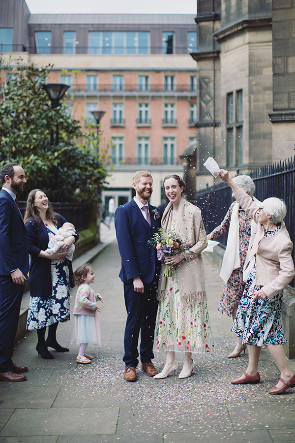 Candid moments from a Sheffield Town Hall wedding with guests celebrating outside