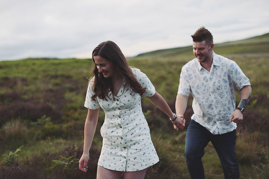 Diana & Alex ♡ Peak District Engagement Photoshoot 19 Relaxed engagement portrait of Diana and Alex outdoors in the Peak District landscape.