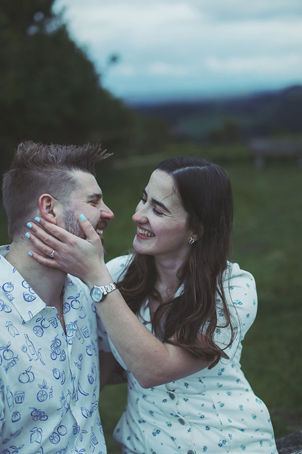 Diana & Alex ♡ Peak District Engagement Photoshoot 22 Couple standing among ferns in the Peak District, sharing a quiet moment during their engagement shoot.