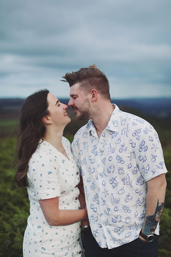 Diana & Alex ♡ Peak District Engagement Photoshoot 16 Relaxed engagement portrait of Diana and Alex outdoors in the Peak District landscape.