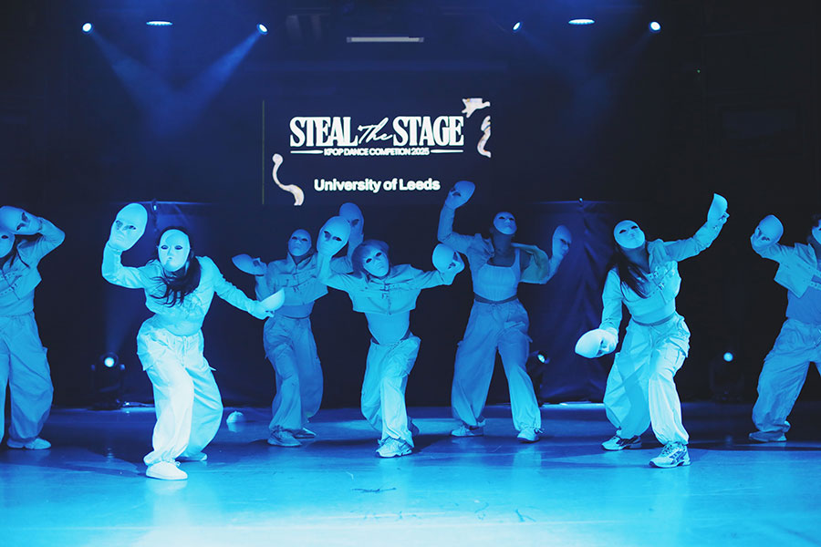 UK Kpop Dance Competition ♡ Steal The Stage 2025 109 University K-pop society members in coordinated outfits performing sharp formation changes on stage.