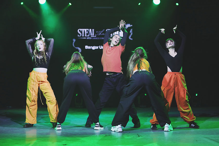UK Kpop Dance Competition ♡ Steal The Stage 2025 11 K-pop dance team performing a high-energy group routine on stage at Steal The Stage 2025, University of Sheffield.