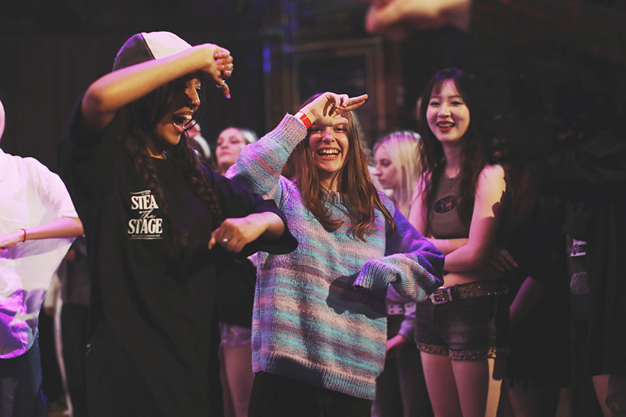 UK Kpop Dance Competition ♡ Steal The Stage 2025 14 Boy group category performers mid-choreography under dramatic purple stage lighting at Steal The Stage 2025.