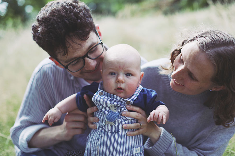 Parents holding their baby in Sheffield Botanical Gardens family photoshoot