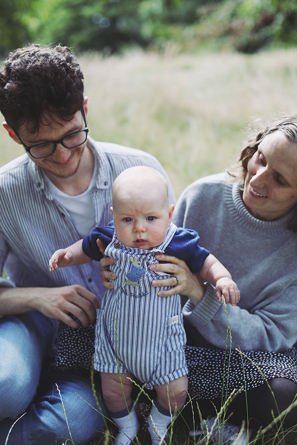 Parents holding their baby in Sheffield Botanical Gardens family photoshoot