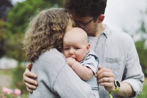 Parents playing with their baby during a summer photoshoot in Sheffield