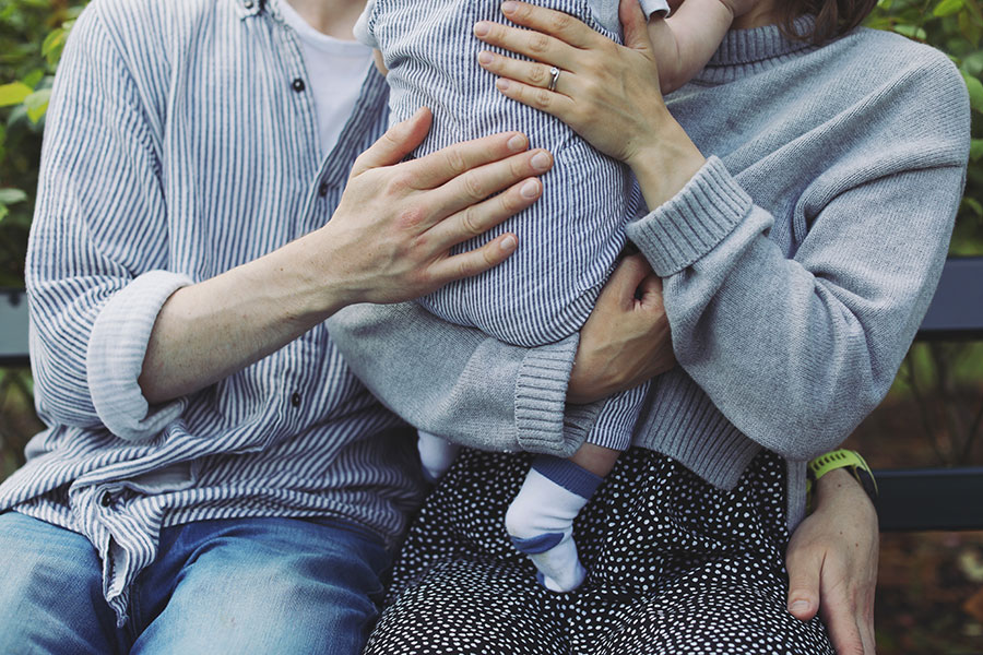 Parents playing with their baby during a summer photoshoot in Sheffield