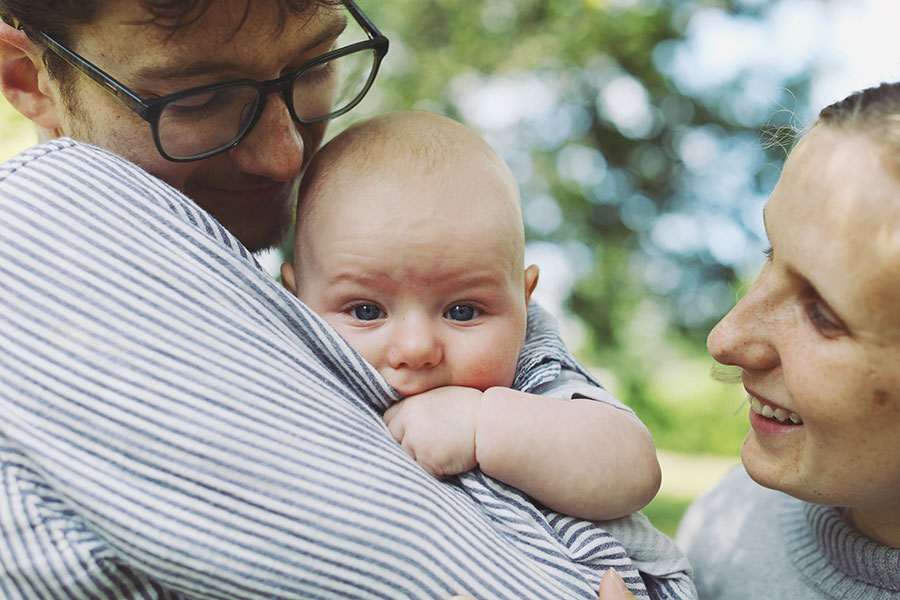 Parents playing with their baby during a summer photoshoot in Sheffield