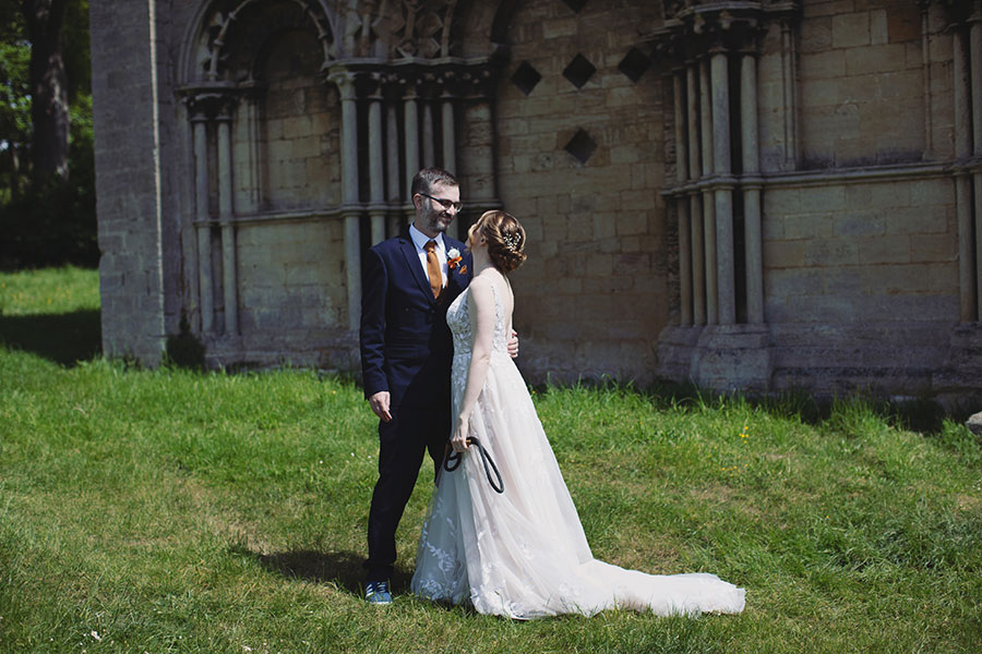 Stamford Registry Office wedding photography of couple walking hand in hand in sunshine