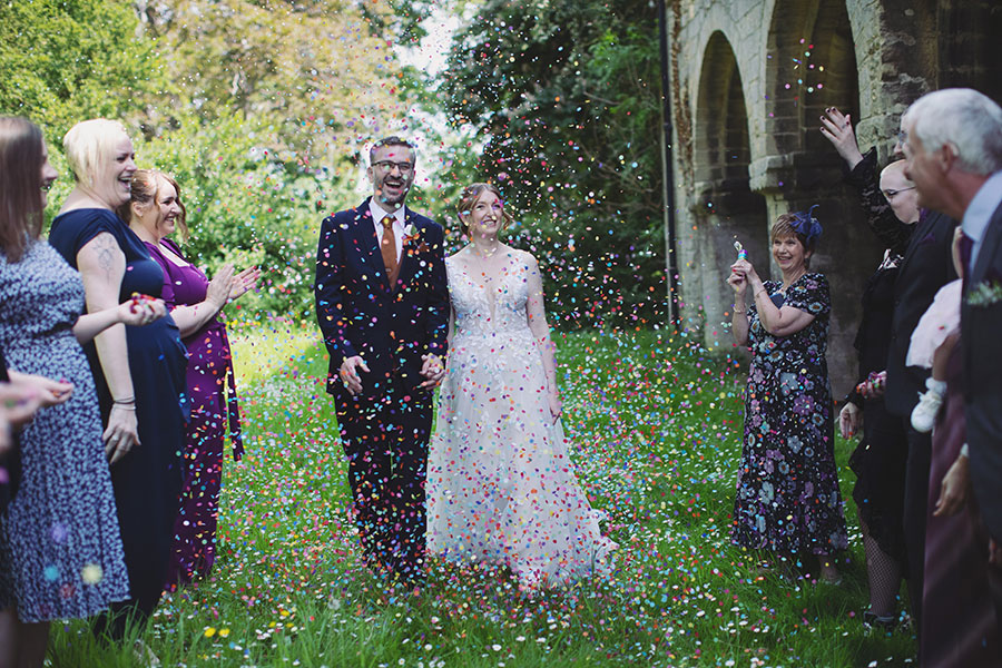 Stamford Registry Office wedding photography of couple walking hand in hand in sunshine