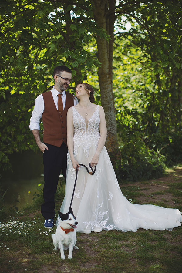 Groom smiling at bride during sunny Stamford Registry Office wedding ceremony
