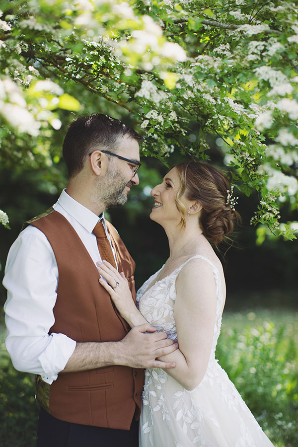 Bride and groom outside Stamford Registry Office on a sunny day with their dog