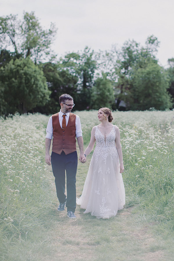 Bride and groom outside Stamford Registry Office on a sunny day with their dog