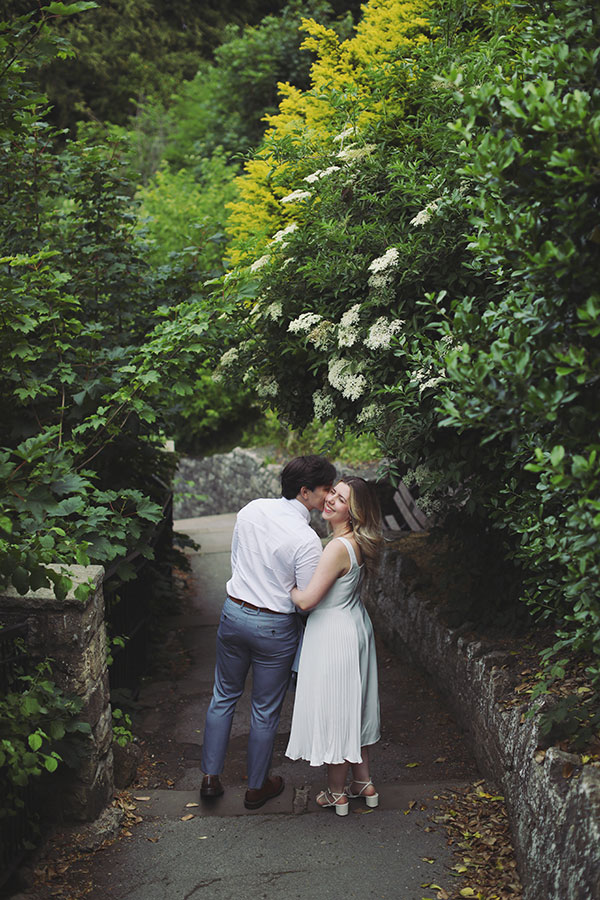 Couple embracing by the riverside in Knaresborough during their engagement session.