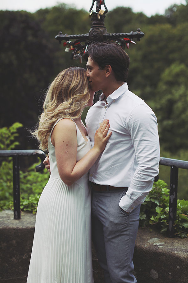 Couple embracing by the riverside in Knaresborough during their engagement session.