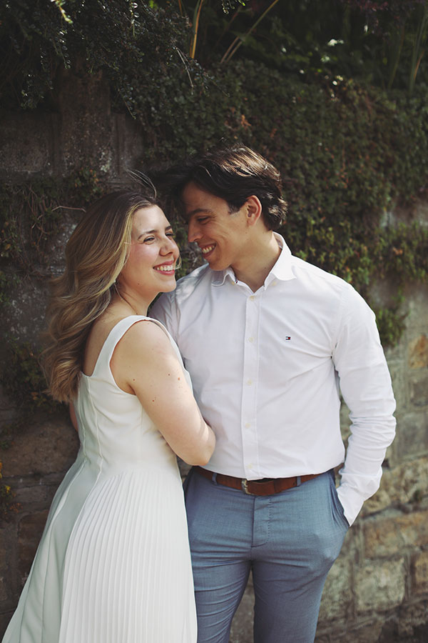 Couple embracing by the riverside in Knaresborough during their engagement session.