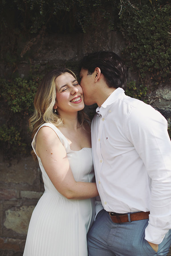 Couple embracing by the riverside in Knaresborough during their engagement session.