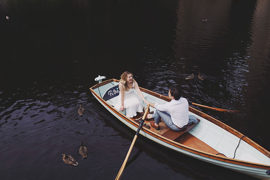 Couple rowing a boat on the River Nidd during a sunny Knaresborough engagement photoshoot.