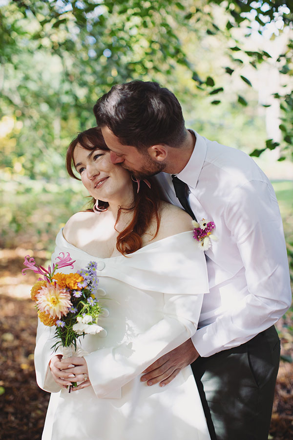 Relaxed Manchester wedding photography portrait of the couple with their dog Pedro after the ceremony